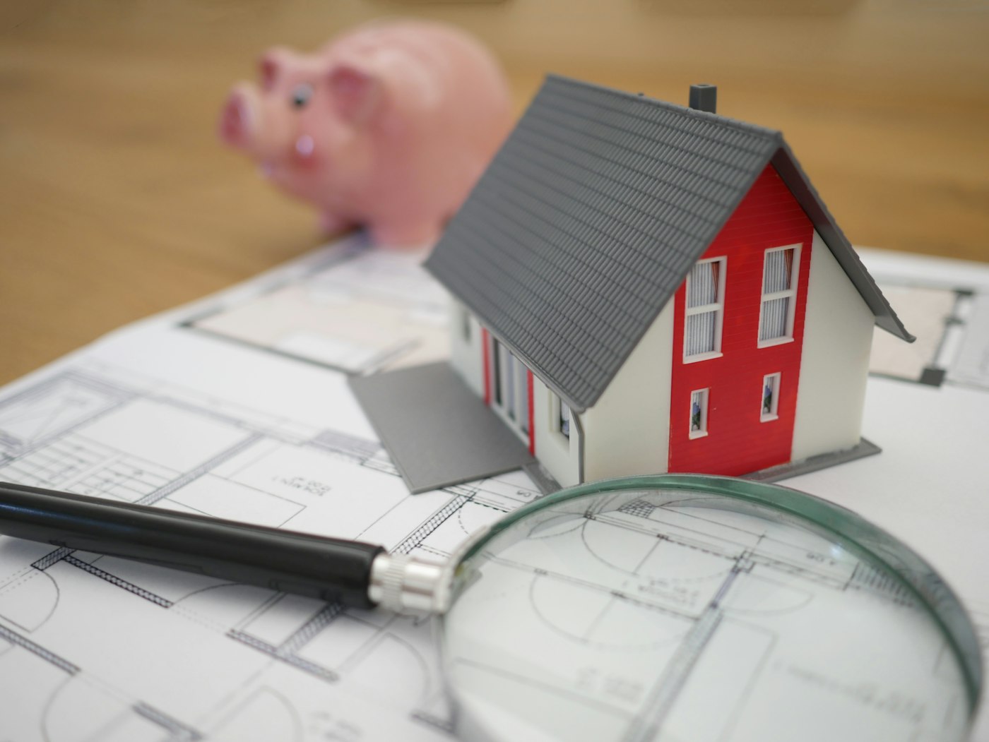 Model home sitting on house blueprints